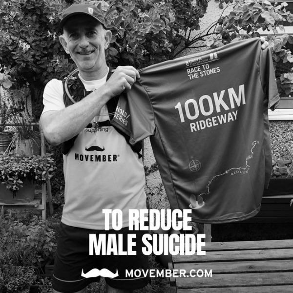 Man in sports attire holding t-shirt to camera that says "100km Ridgeway"