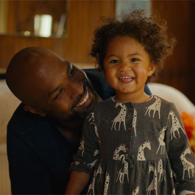 A father looking affectionately towards his young child.