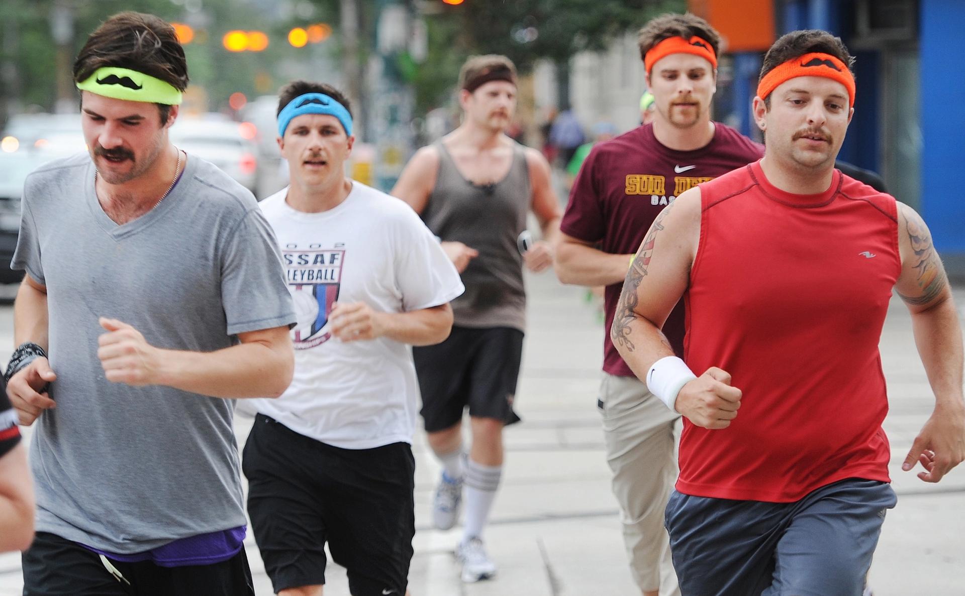 Men with moustaches running