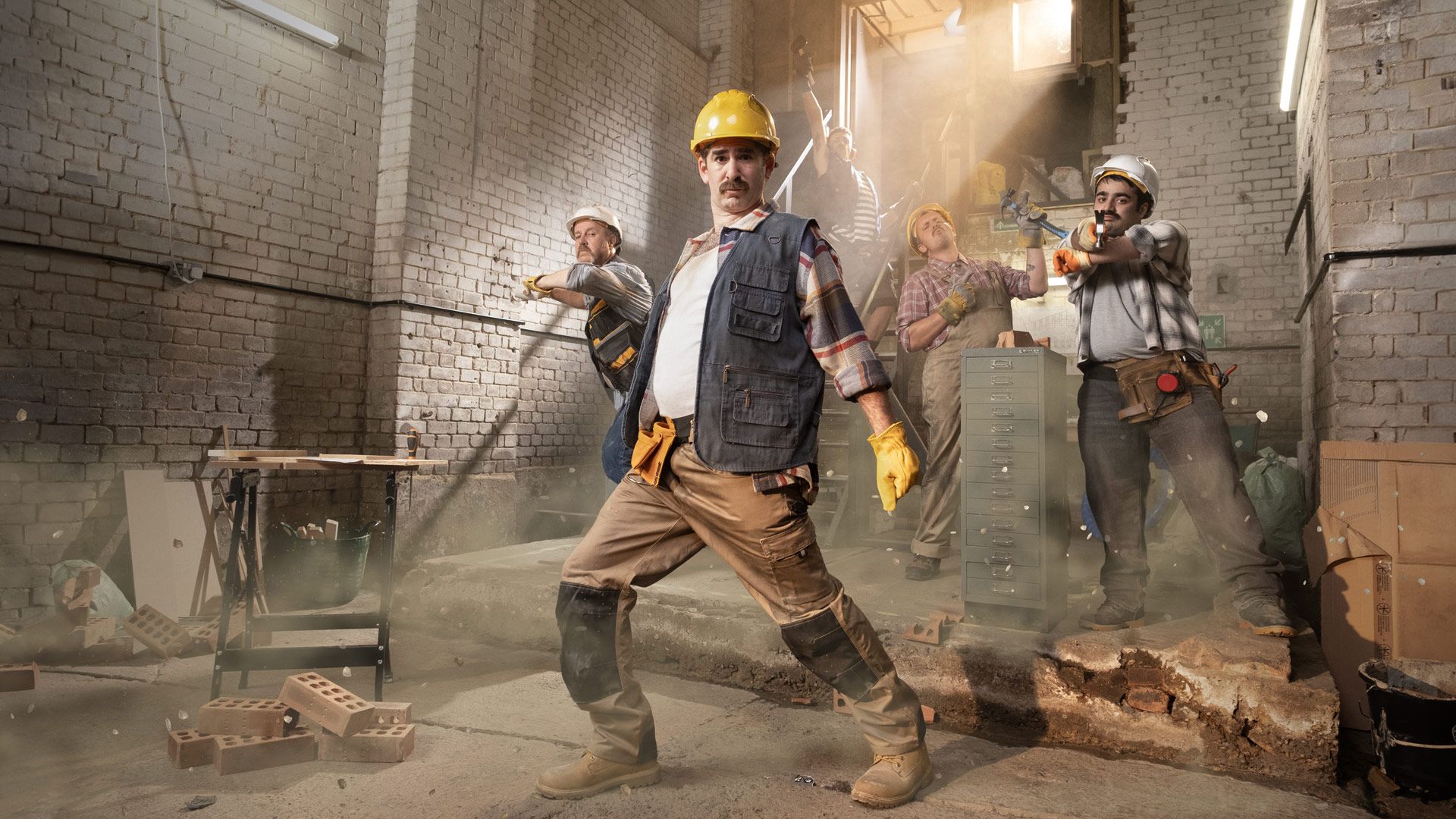 Stylised photo of blue collar men, posing humorously in a factory, to promote movement.