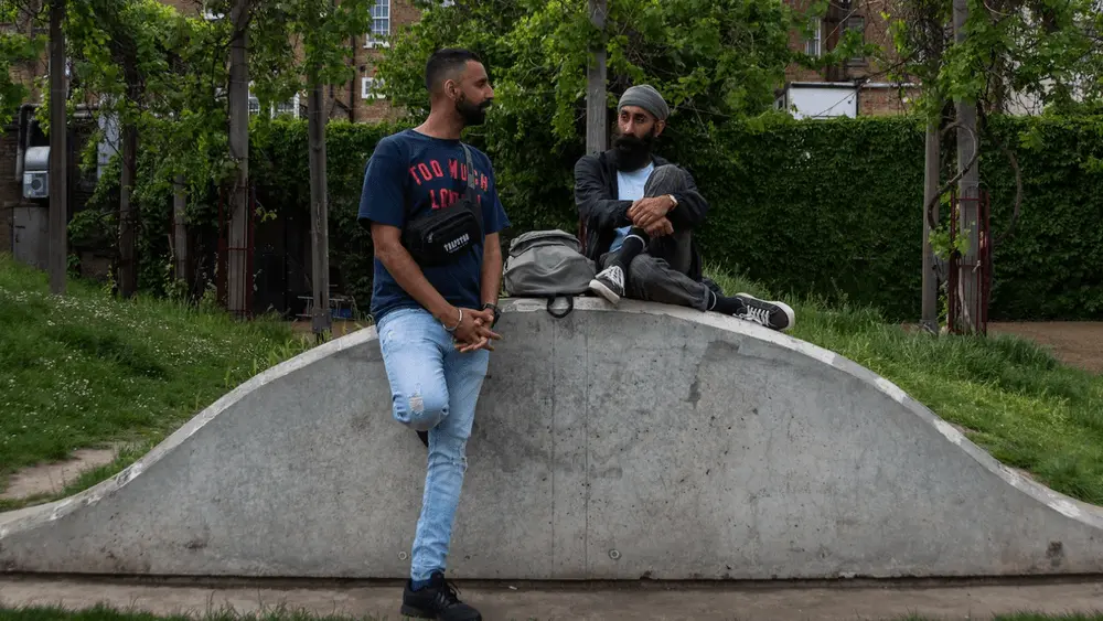 Two men sitting outside talking
