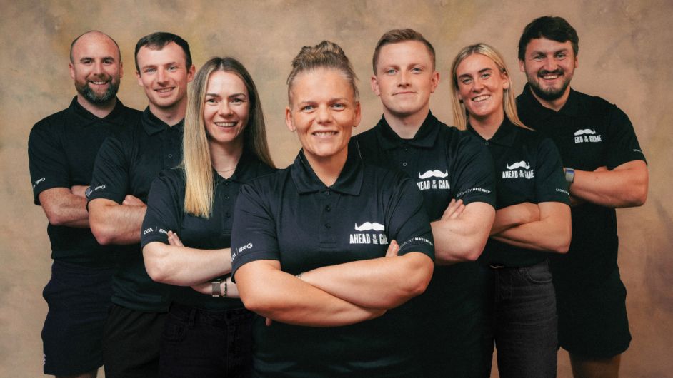 Photo of Irish athletes wearing Movember-branded shorts, smiling to camera.