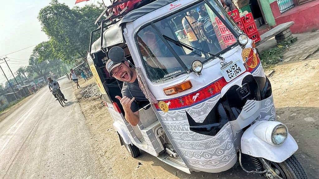 Joshua in his rickshaw car in India