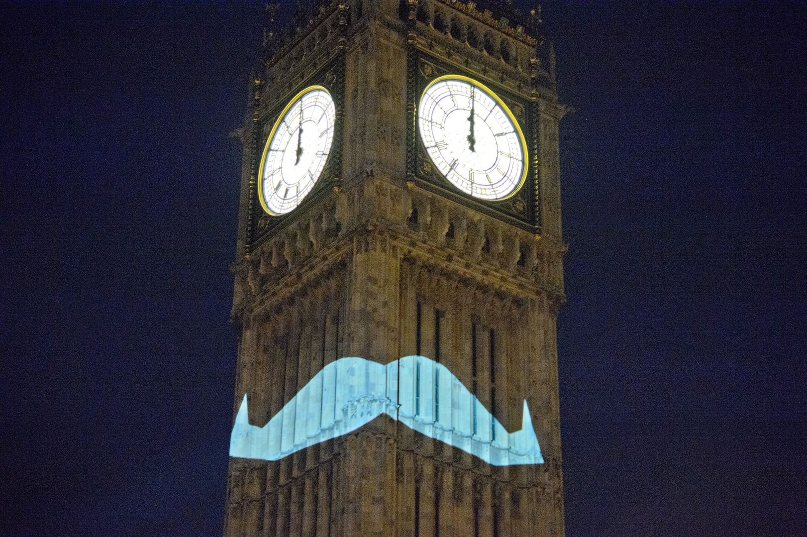 Big Ben with a Moustache Projected On It