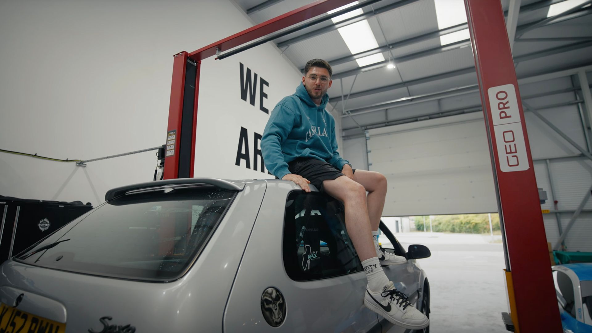 Man sits on top of car