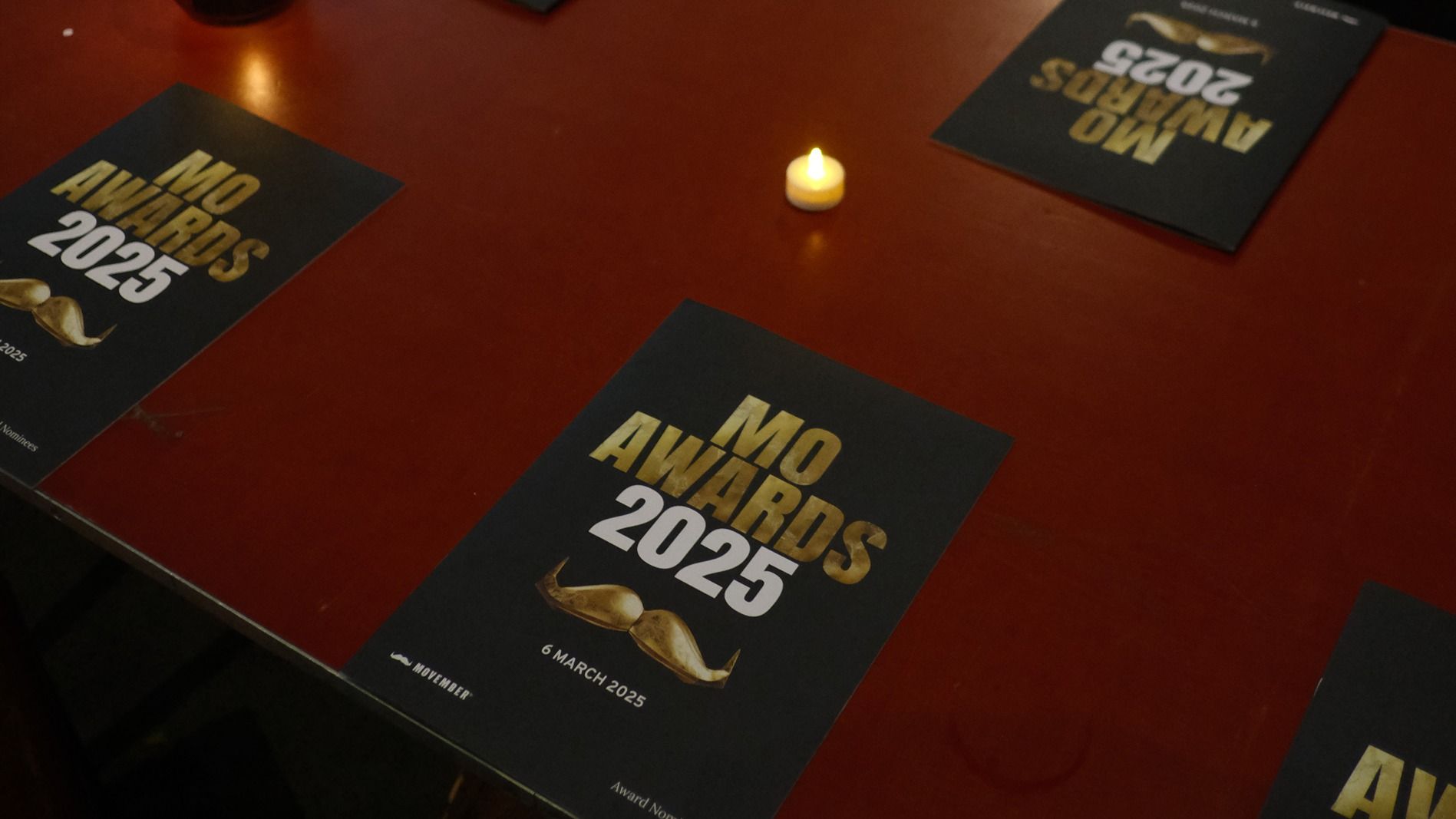 Movember awards brochure on tables