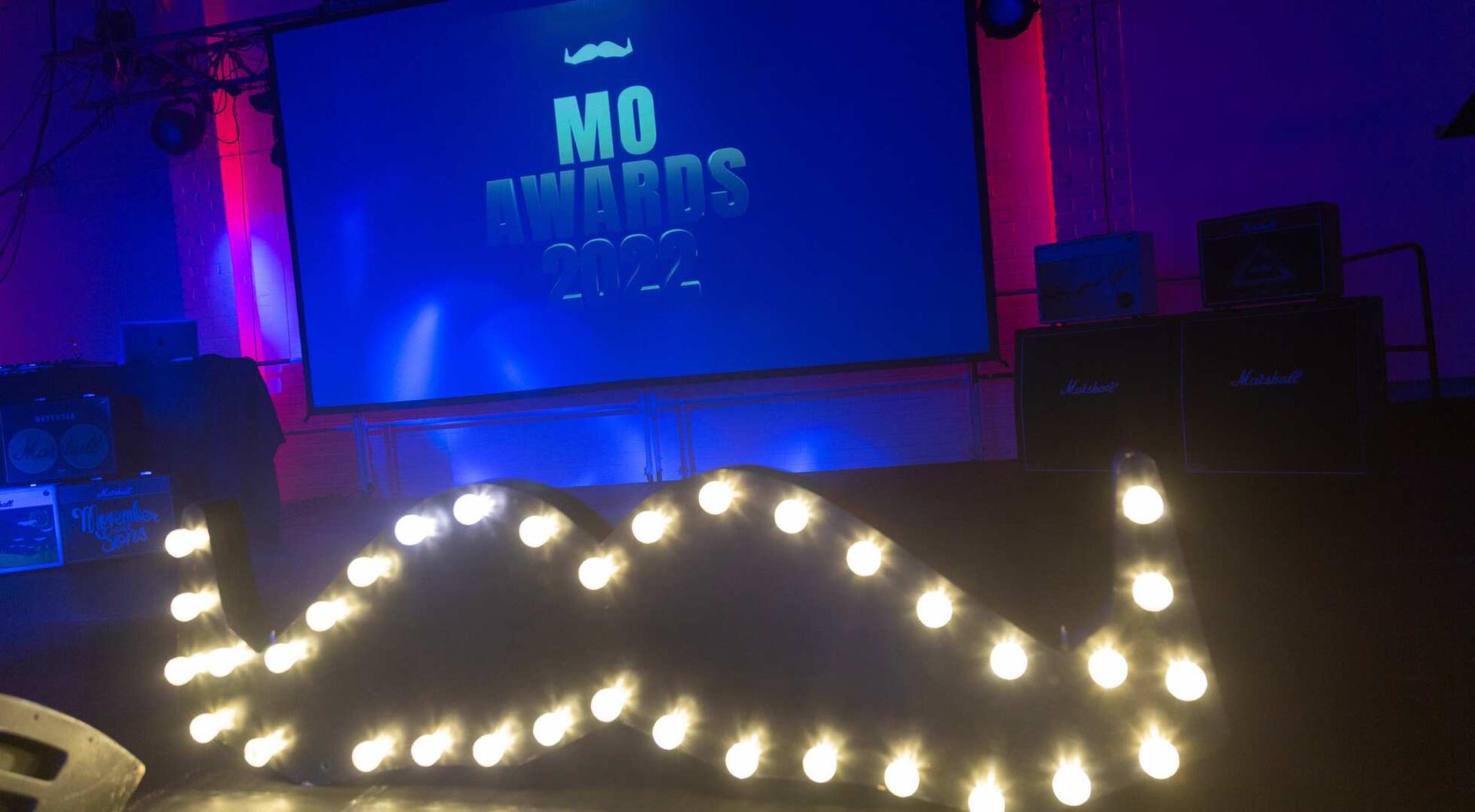 Movember Iconic Mo Logo made out of lights.