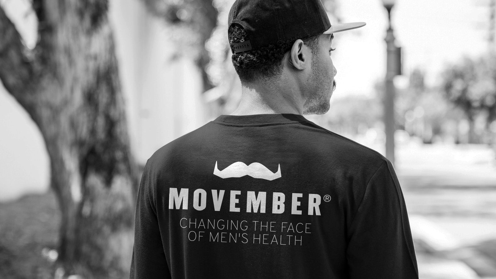 Photo of a man wearing a Movember-branded shirt.