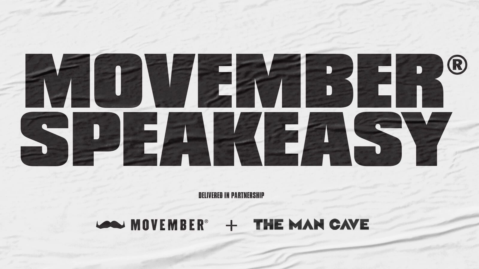 A white mural poster. In bold black font it reads: "MOVEMBER SPEAKEASY. Delivered in partnership: Movember + The Man Cave."