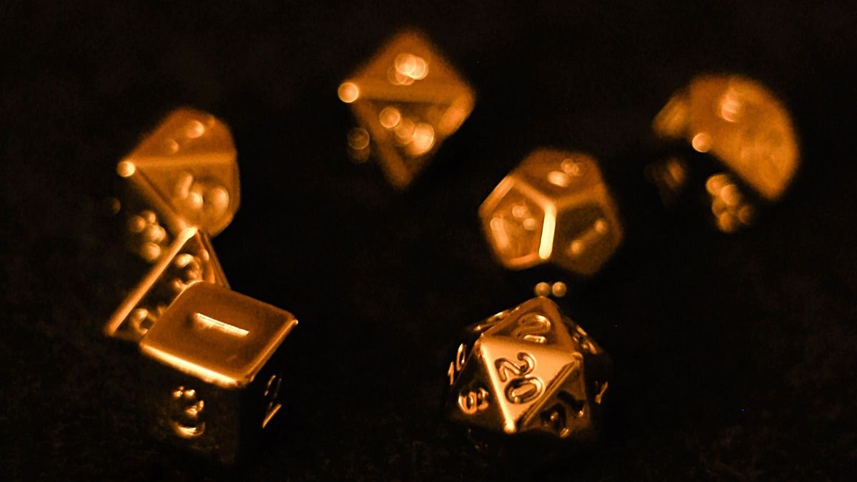 Gold dice on a black surface