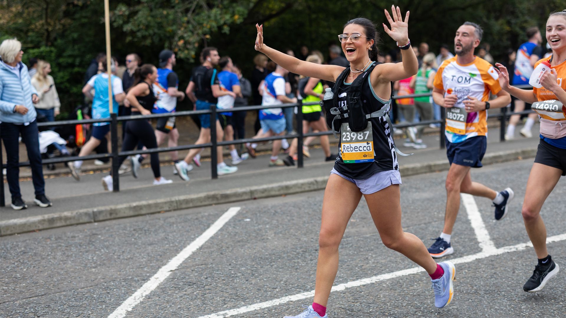 Photo of Movember runner waving to crowd.