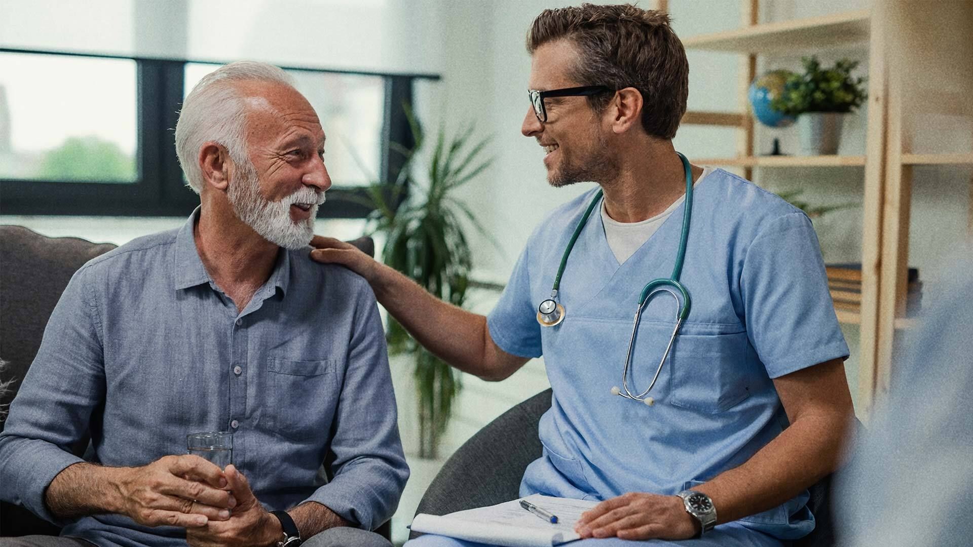 A male doctor talking with a male patient