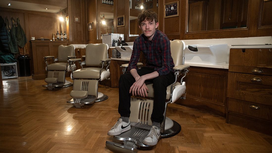 Fergus sat in a barber chair facing camera
