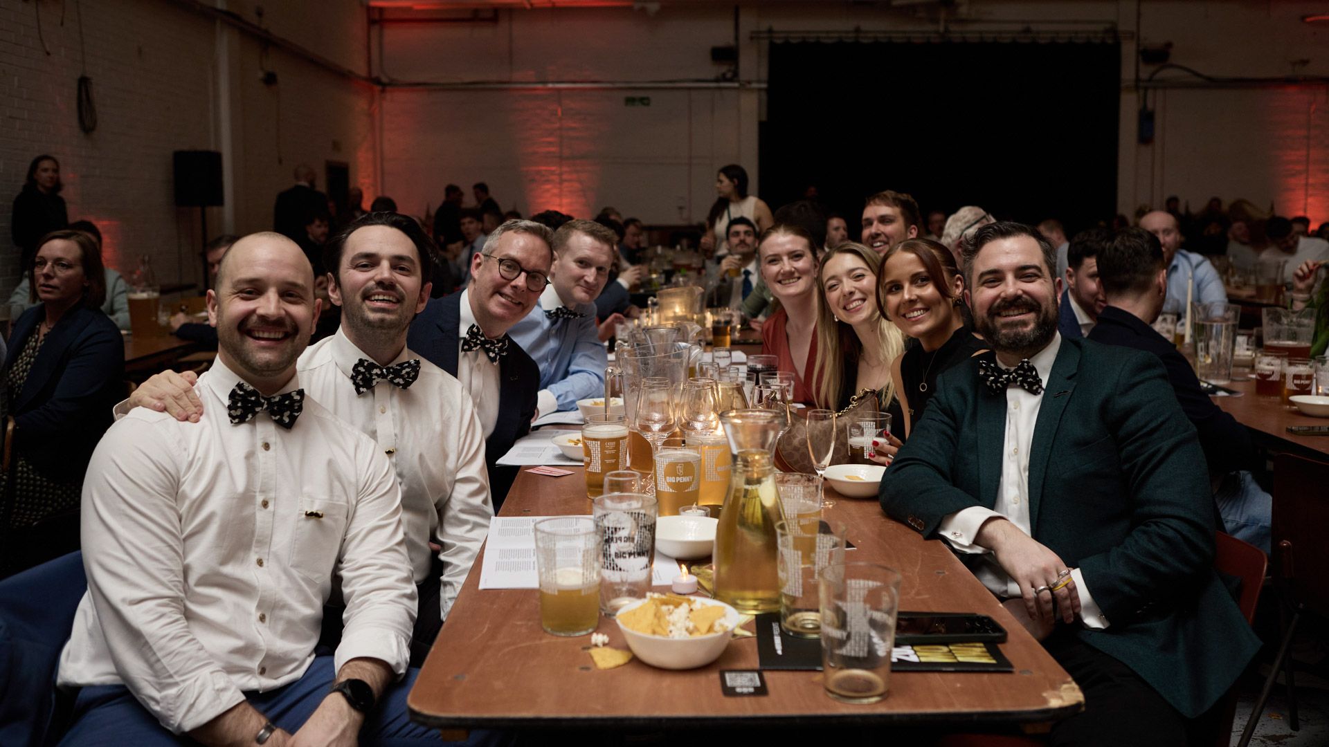 Group of people with moustaches at dinner table